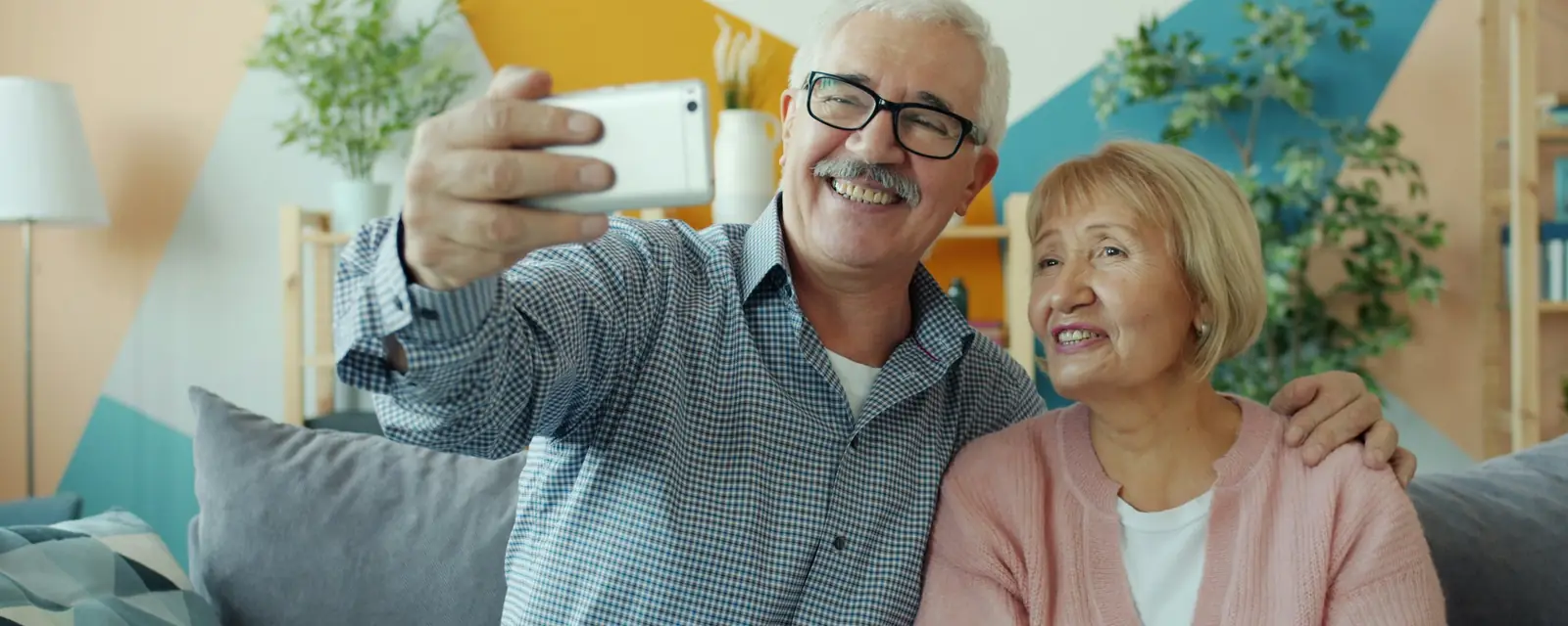 Older couple laughing together at home