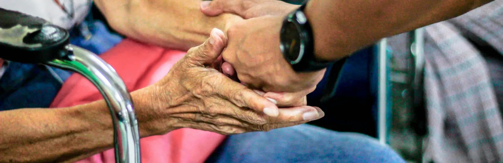 Two people holding hands in support