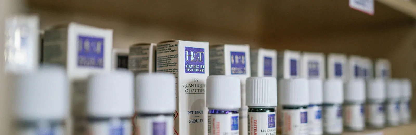 Prescription bottles lined up on a pharmacy counter