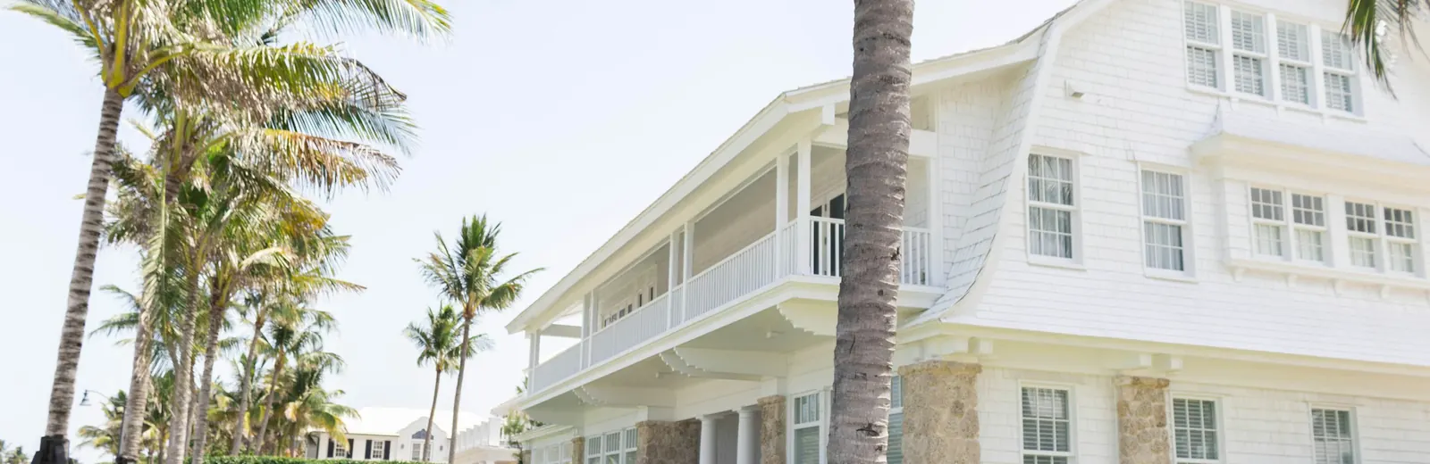 Family home with a car in the driveway on a bright Florida morning