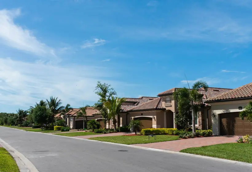 Family home with a car in the driveway on a bright Florida morning
