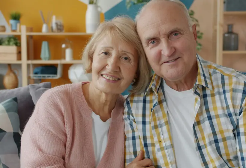 Older couple reviewing paperwork together with an advisor