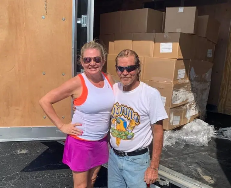 Volunteers unloading boxed supplies from the relief trailer