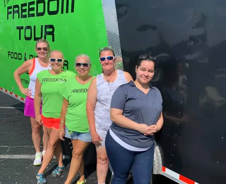 Team members in Freedom Tour shirts at a community relief event