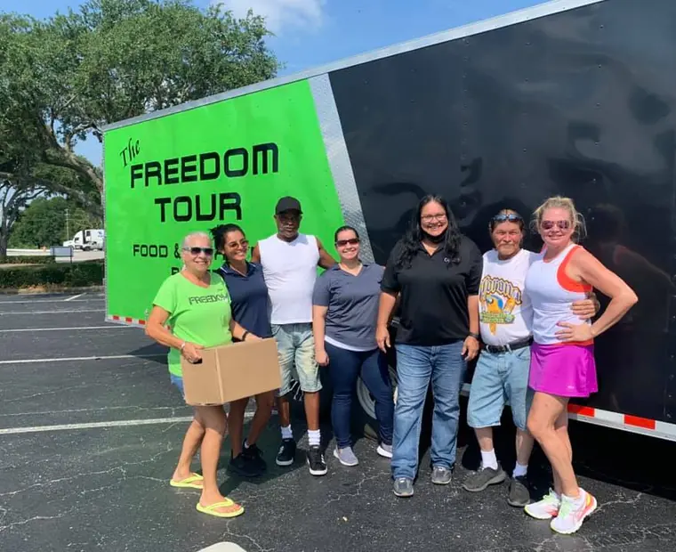 Group photo at the Freedom Tour trailer in a Winter Haven car park